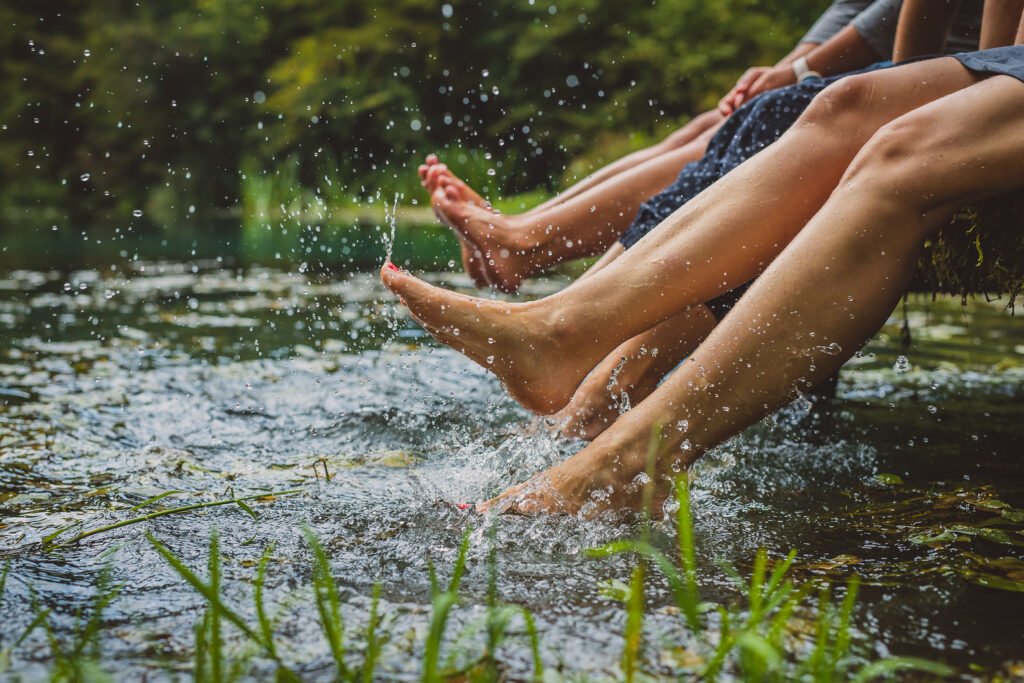 women splashing feet in water